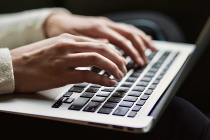 person-typing-on-a-mac-keyboard