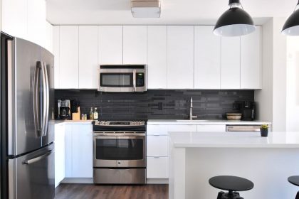 naomi-hebert-white-kitchen-black-stools-silver-appliances